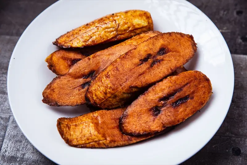 Stekt plantain på vit tallrik